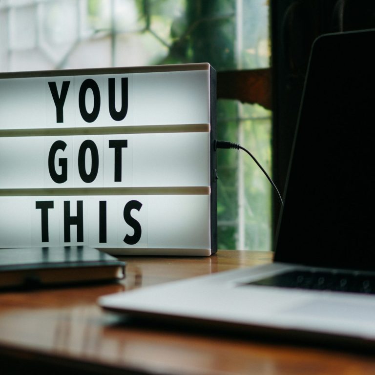 Lightbox displaying the words "You Got This" next to a laptop on a wooden table.